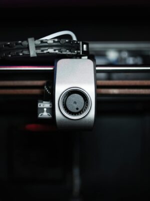 Macro shot of a 3D printer nozzle highlighting technology and precision.